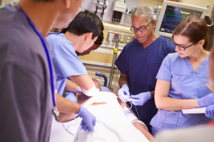 doctors and nurses working on a patient in the emergency room