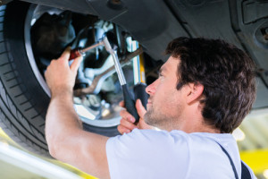 A repairman fixing a defective tire