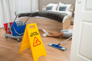 man laying on hotel floor after slipping from wet floor