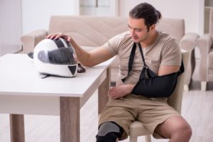 man sitting after motorcycle accident