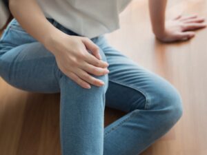 Woman holds her injured knee