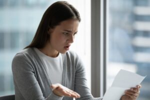 concerned woman looking at a document