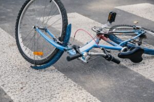 childrens bicycle lying on street