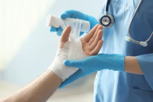 medical assistant applying bandage into patient