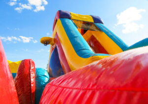 large inflatable bounce house colored red, yellow, and blue
