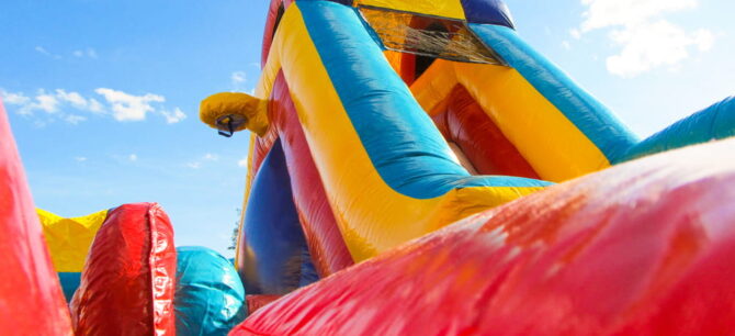 large inflatable bounce house colored red, yellow, and blue