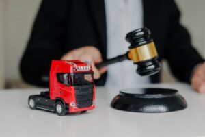 Judge hitting Gavel with toy cargo truck on the table
